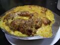 Galinha à Portuguesa, a dish of chicken with potatoes and vegetables in a coconut milk sauce.
