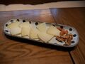 A plate of 12-month aged Manchego cheese with nuts.