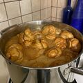 Browned teiglach boiling in honey
