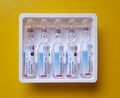 Urapidil 25mg/5ml vials on a yellow background