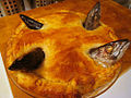 A freshly baked stargazy pie with golden brown crust.