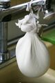 Cheese in cheesecloth sink