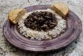 Frijoles negros served on a plate.