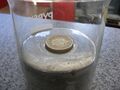 Pound coin floating in mercury
