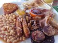 A full English breakfast with eggs, bacon, and beans