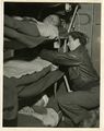 A nurse attending to a patient aboard a C-47 during World War II