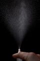 Action photo of nasal spray on a black background