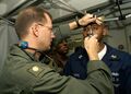 U.S. Navy Flight Surgeon, Lt. Cmdr. Scott Carlson performs an eye examination