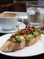 Avocado salad with tomato salsa on toasted baguette